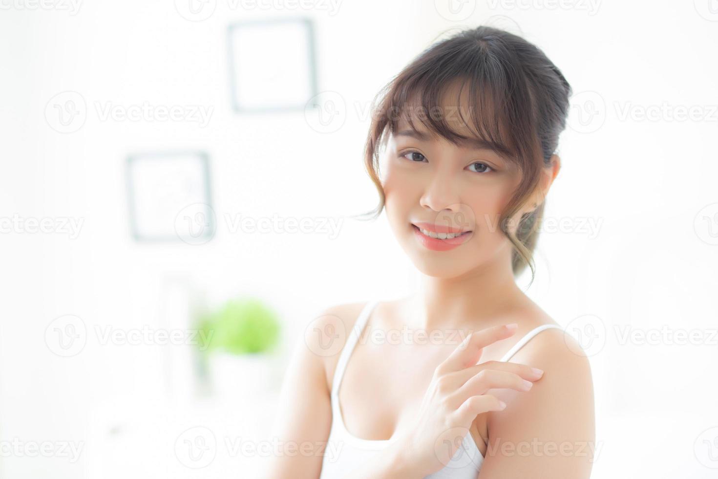 Beautiful asian woman applying cream and treatment for skin care touch on shoulder, asia girl with lotion spa and moisturizing for health and wellness body part, lifestyle and beauty cosmetic concept. photo