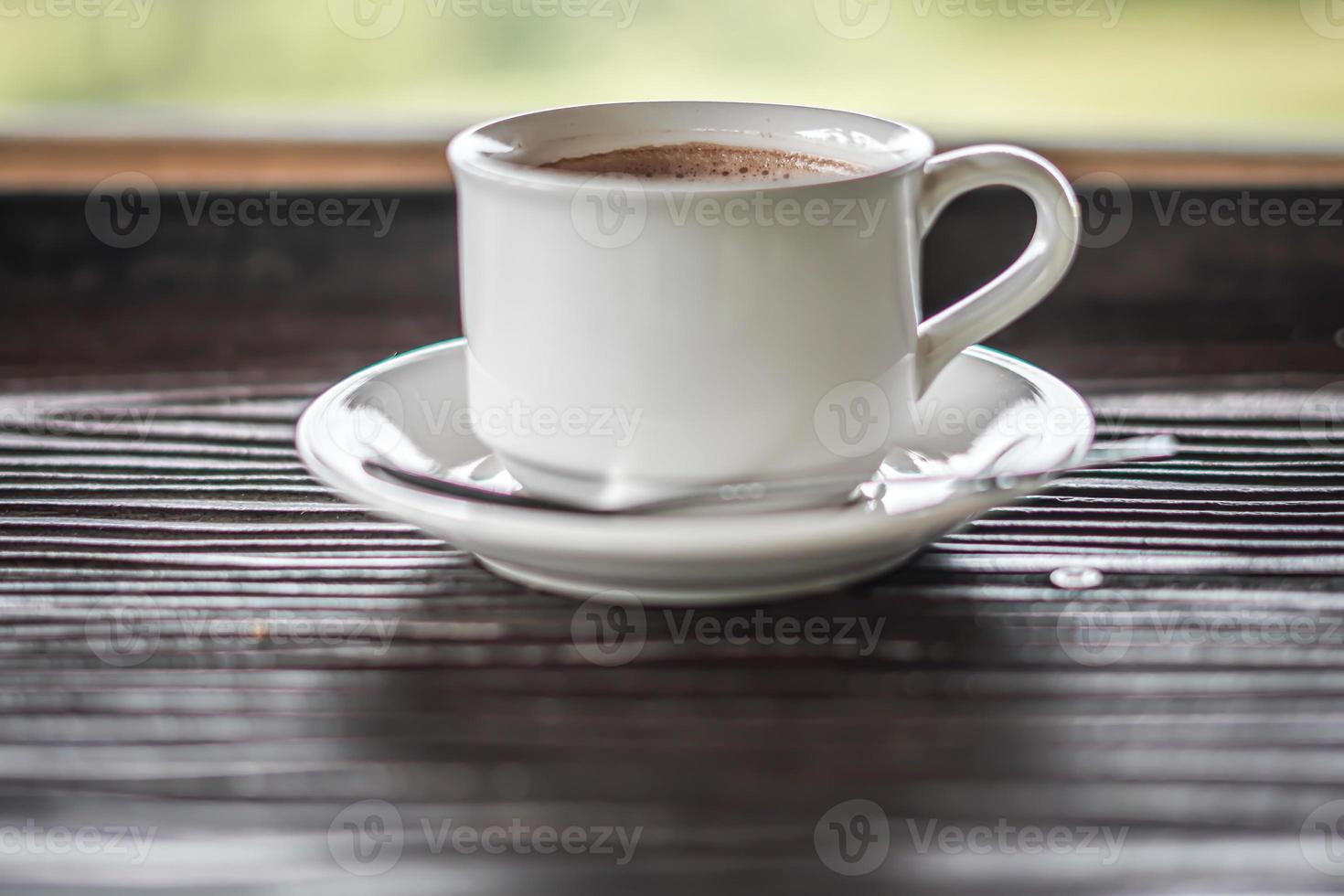 aesthetic a cup of coffee on wooden background photo