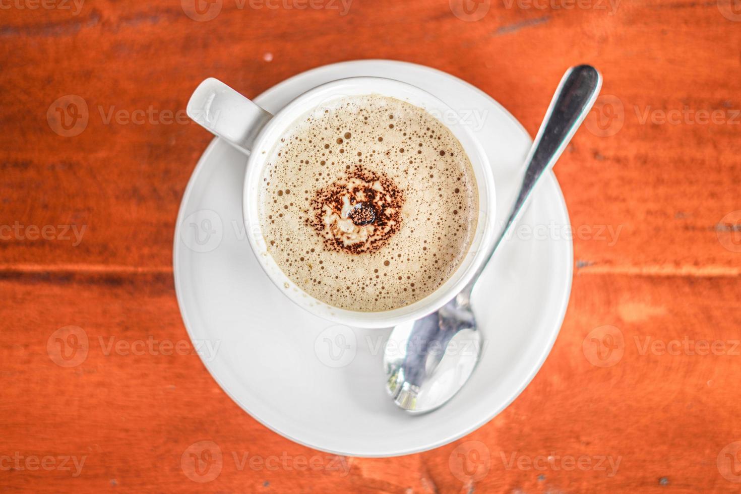 aesthetic a cup of coffee on wooden background photo