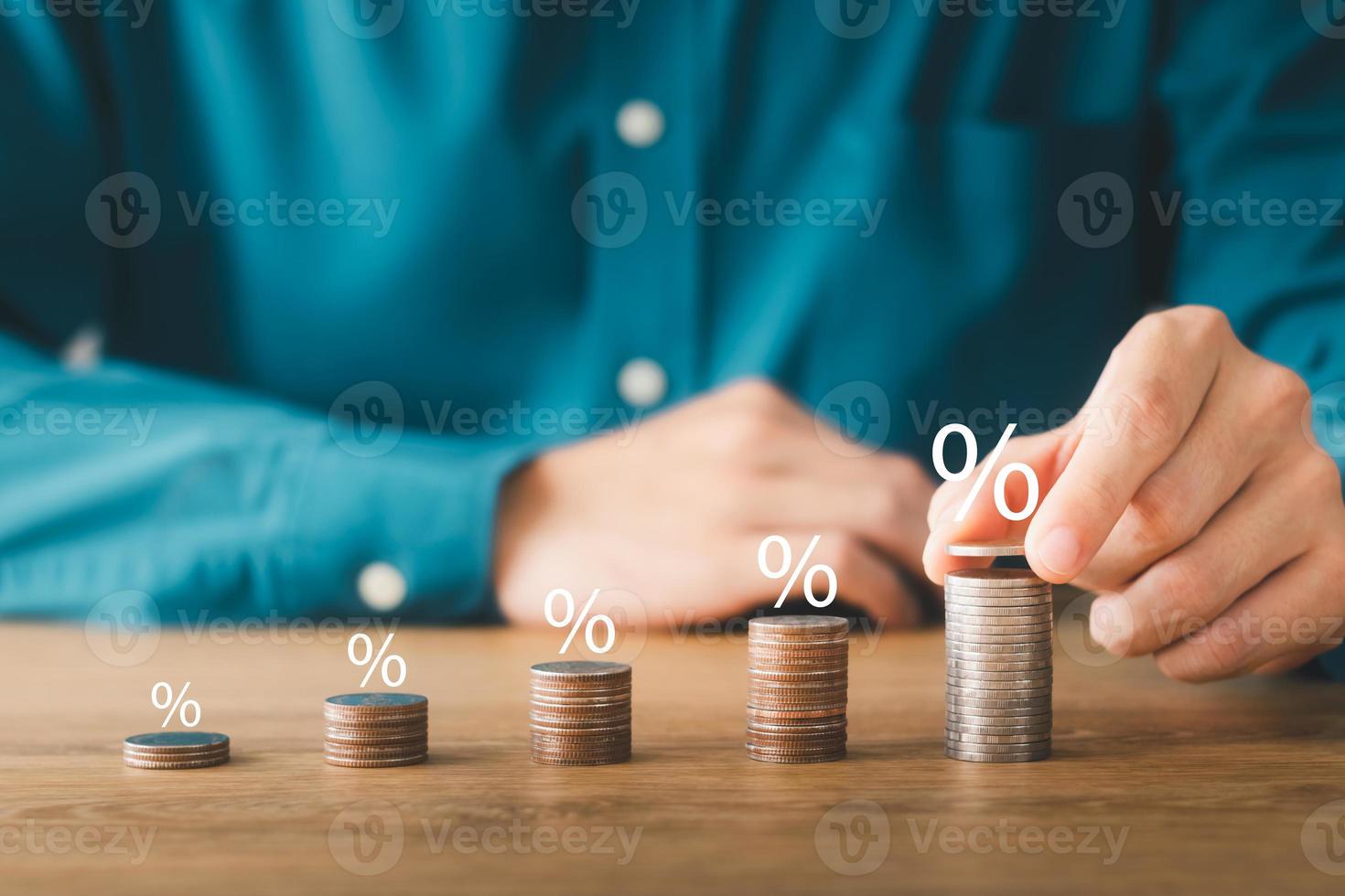 Interest rate and dividend concept, wooden block with percentage symbol, return on stocks and mutual funds, long term investment for retirement. photo
