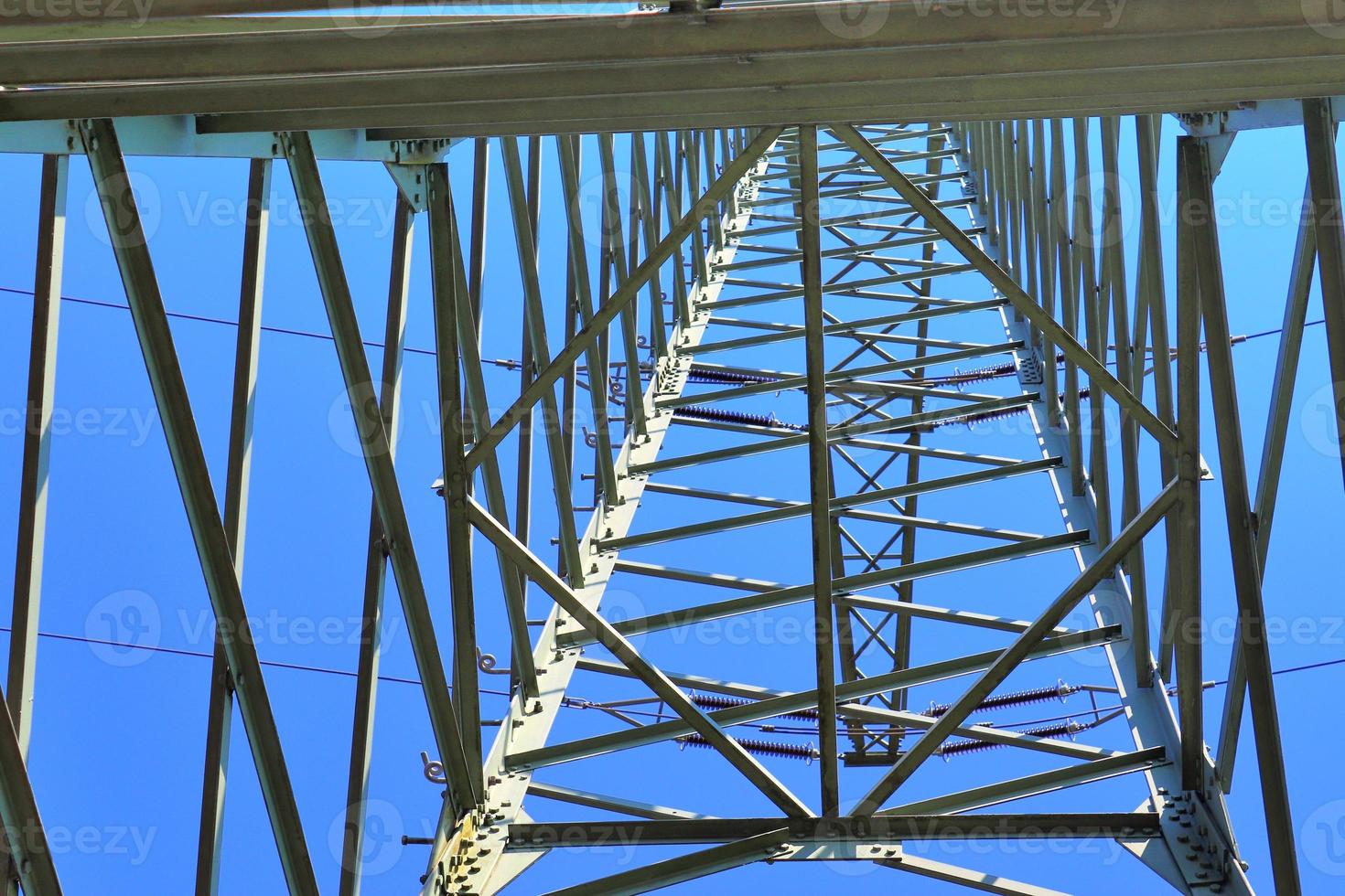 Close up view on a big power pylon transporting electricity in a countryside area photo