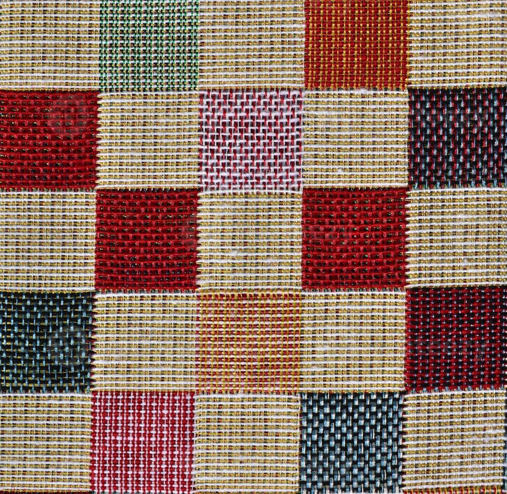 Detailed close up view on samples of cloth and fabrics in different colors found at a fabrics market photo
