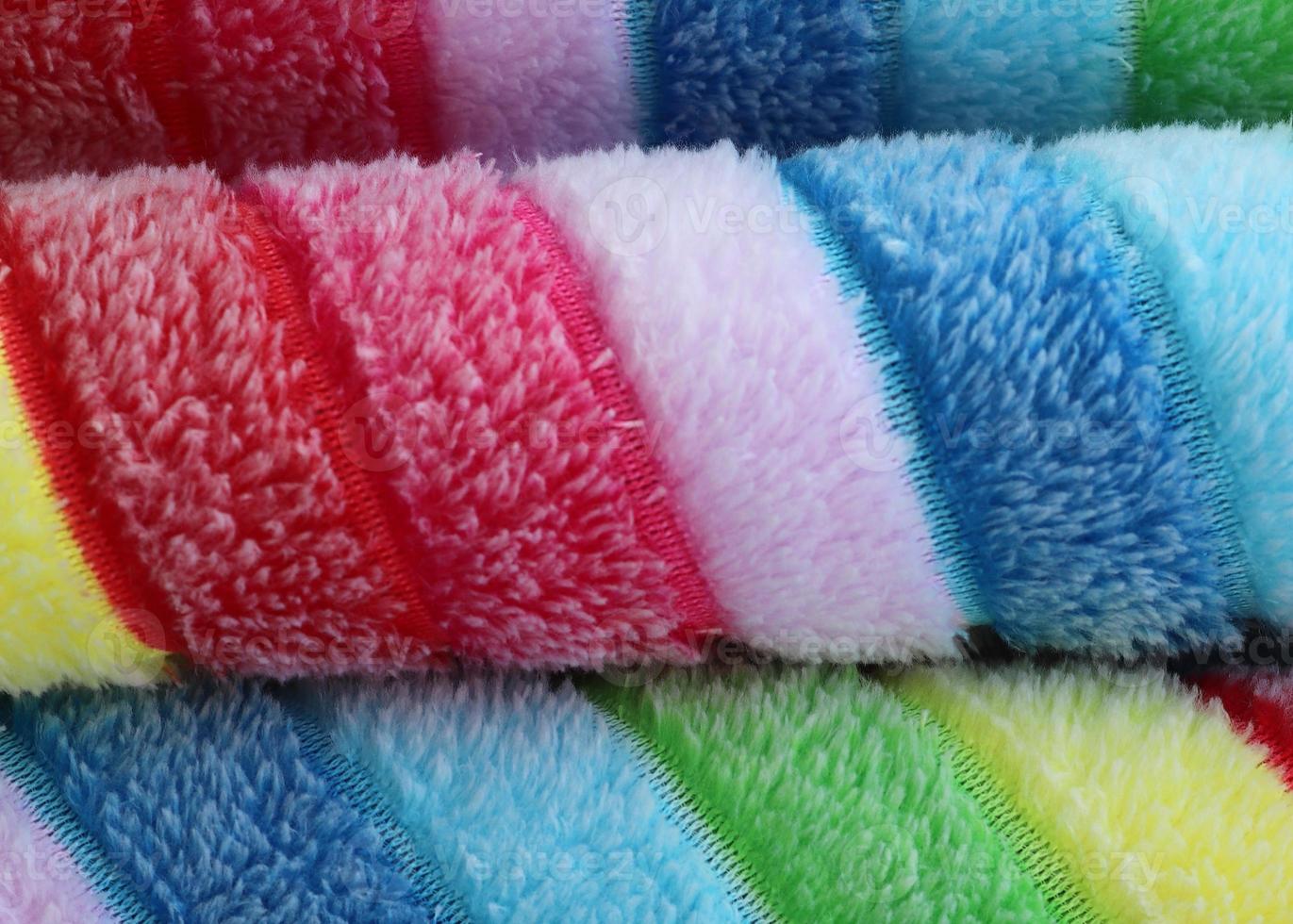 Detailed close up view on samples of cloth and fabrics in different colors found at a fabrics market photo