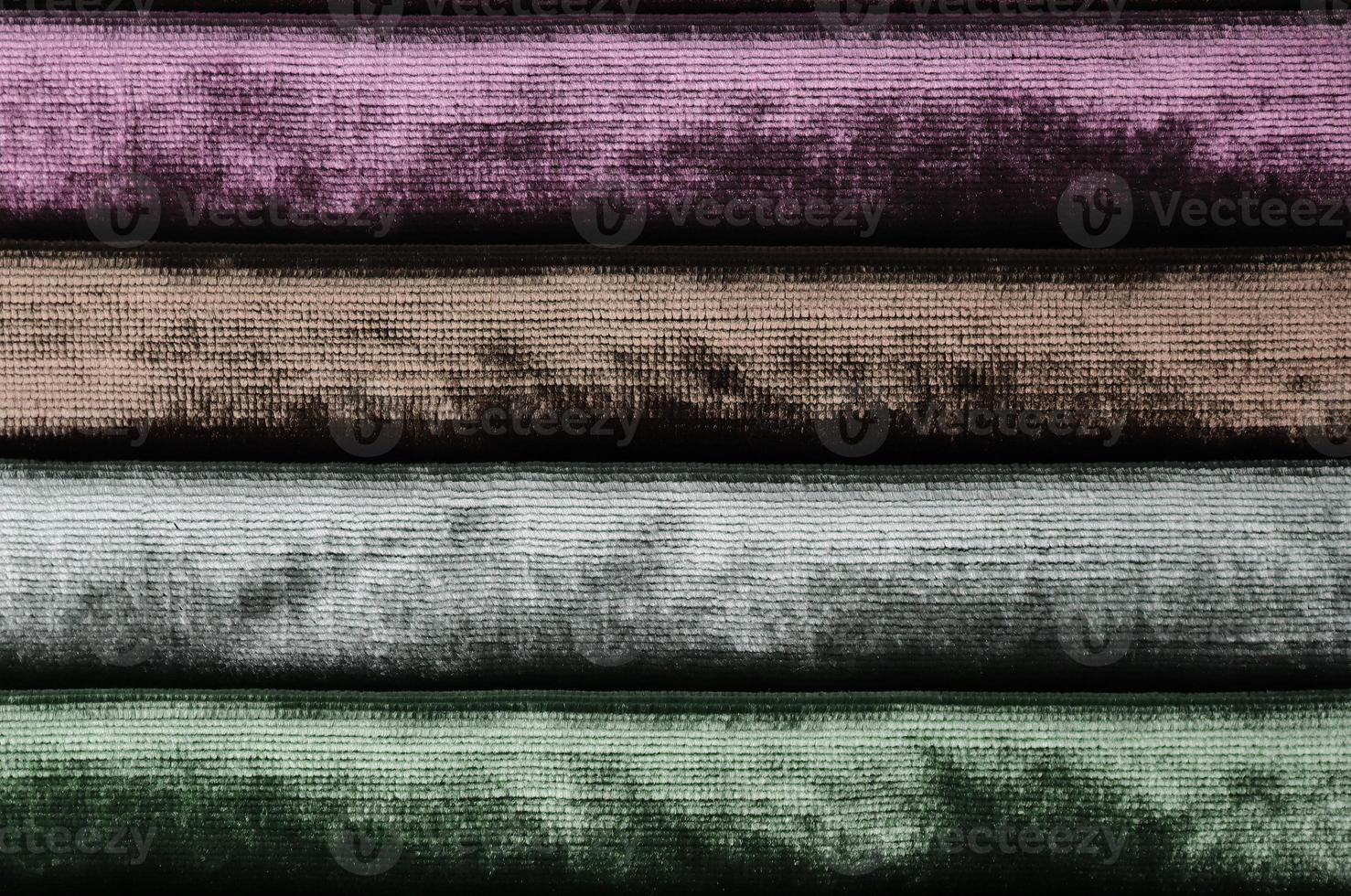 Detailed close up view on samples of cloth and fabrics in different colors found at a fabrics market photo
