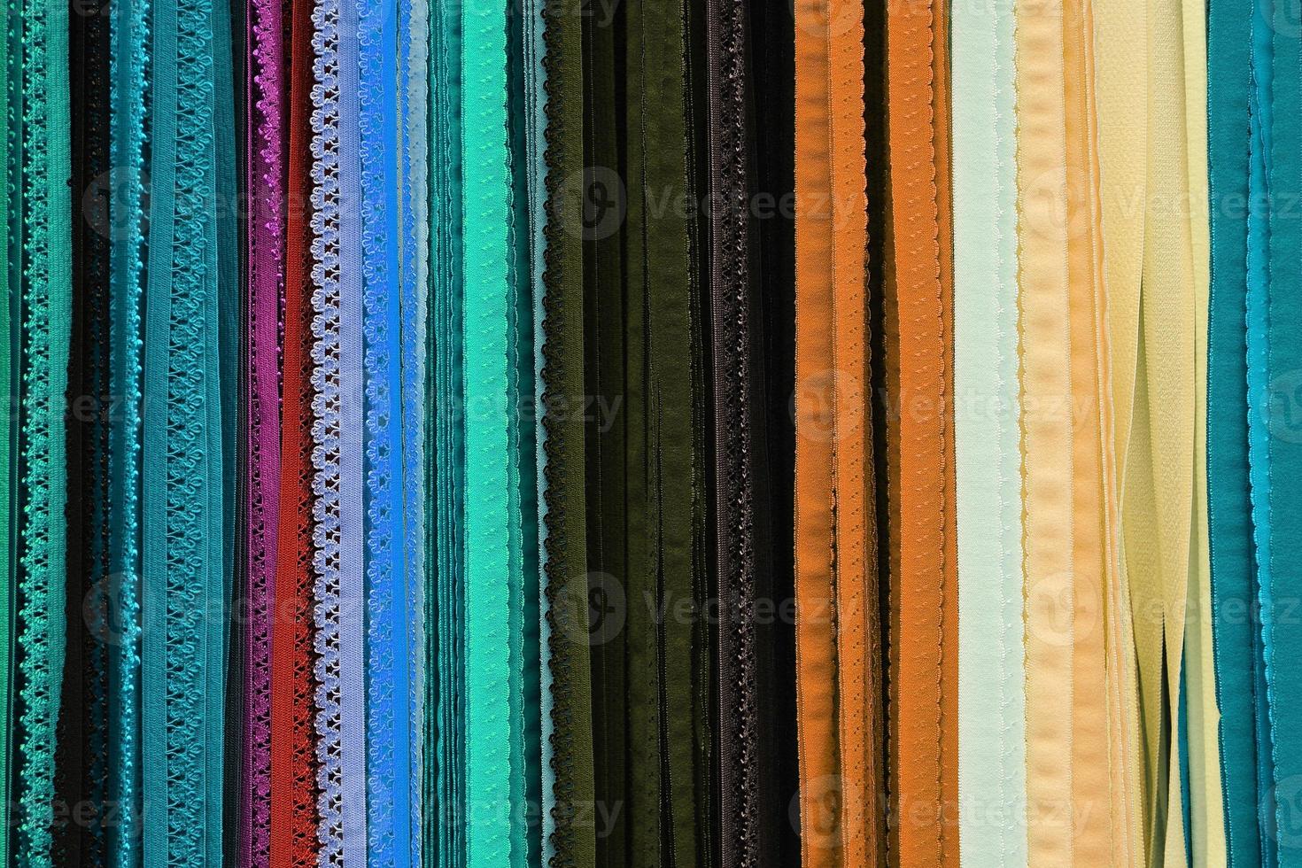 Detailed close up view on samples of cloth and fabrics in different colors found at a fabrics market photo
