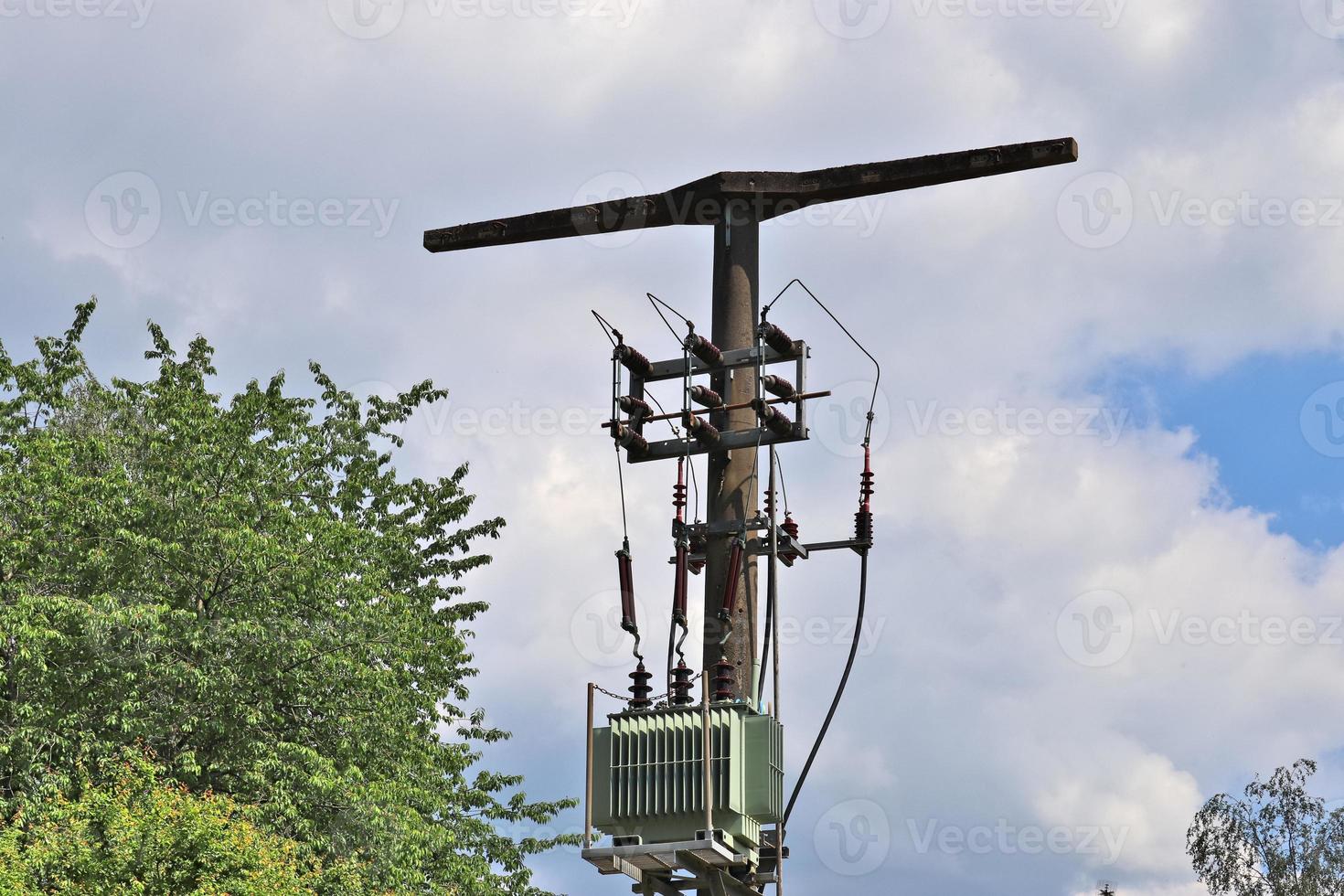 Close up view on a big power pylon transporting electricity in a countryside area photo