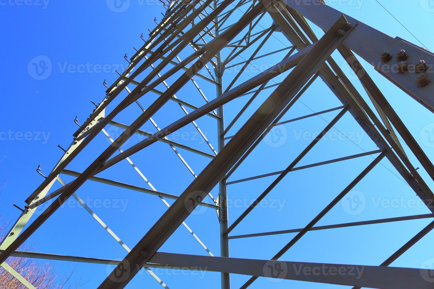 Close up view on a big power pylon transporting electricity in a countryside area photo