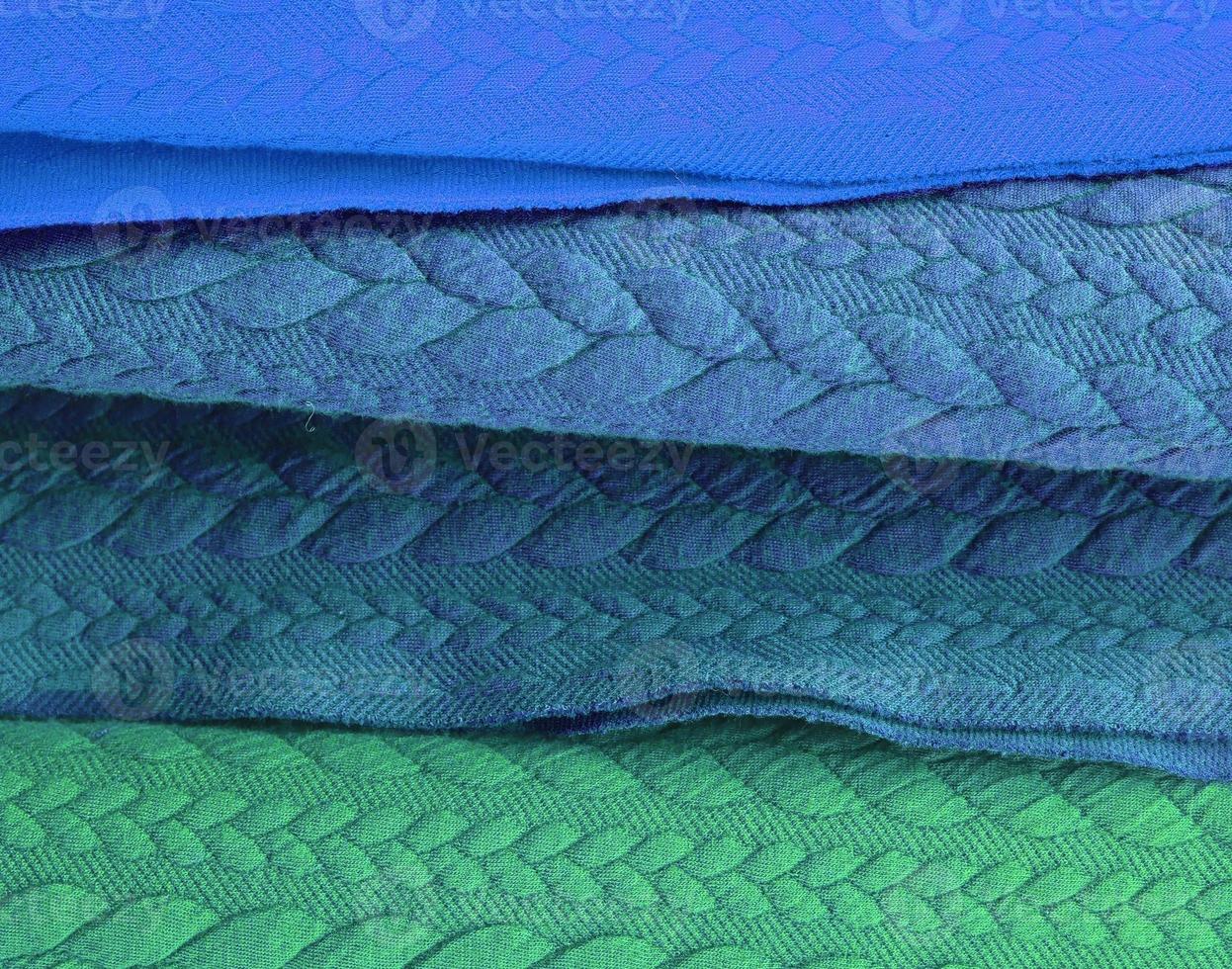 Detailed close up view on samples of cloth and fabrics in different colors found at a fabrics market photo