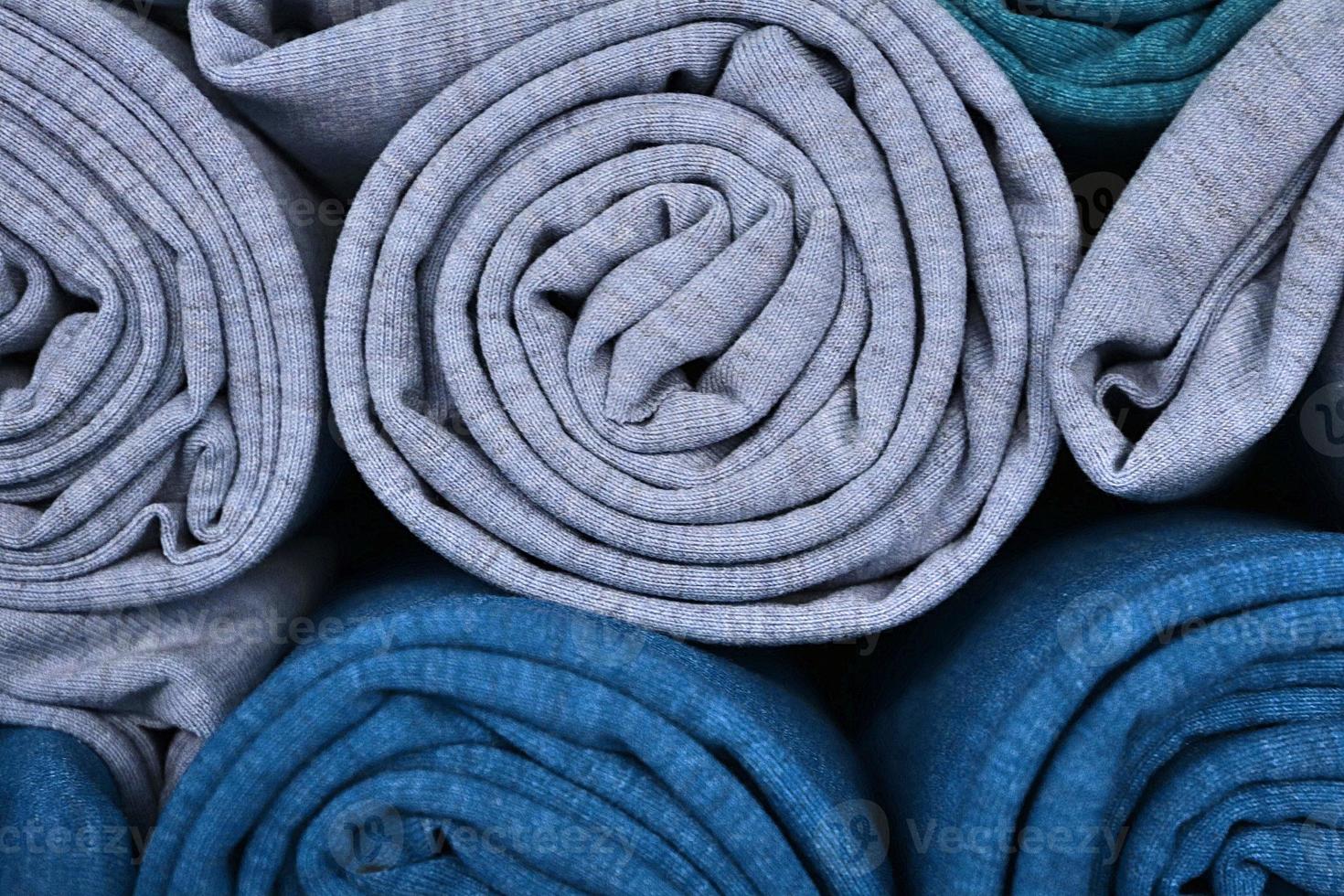 Detailed close up view on samples of cloth and fabrics in different colors found at a fabrics market photo