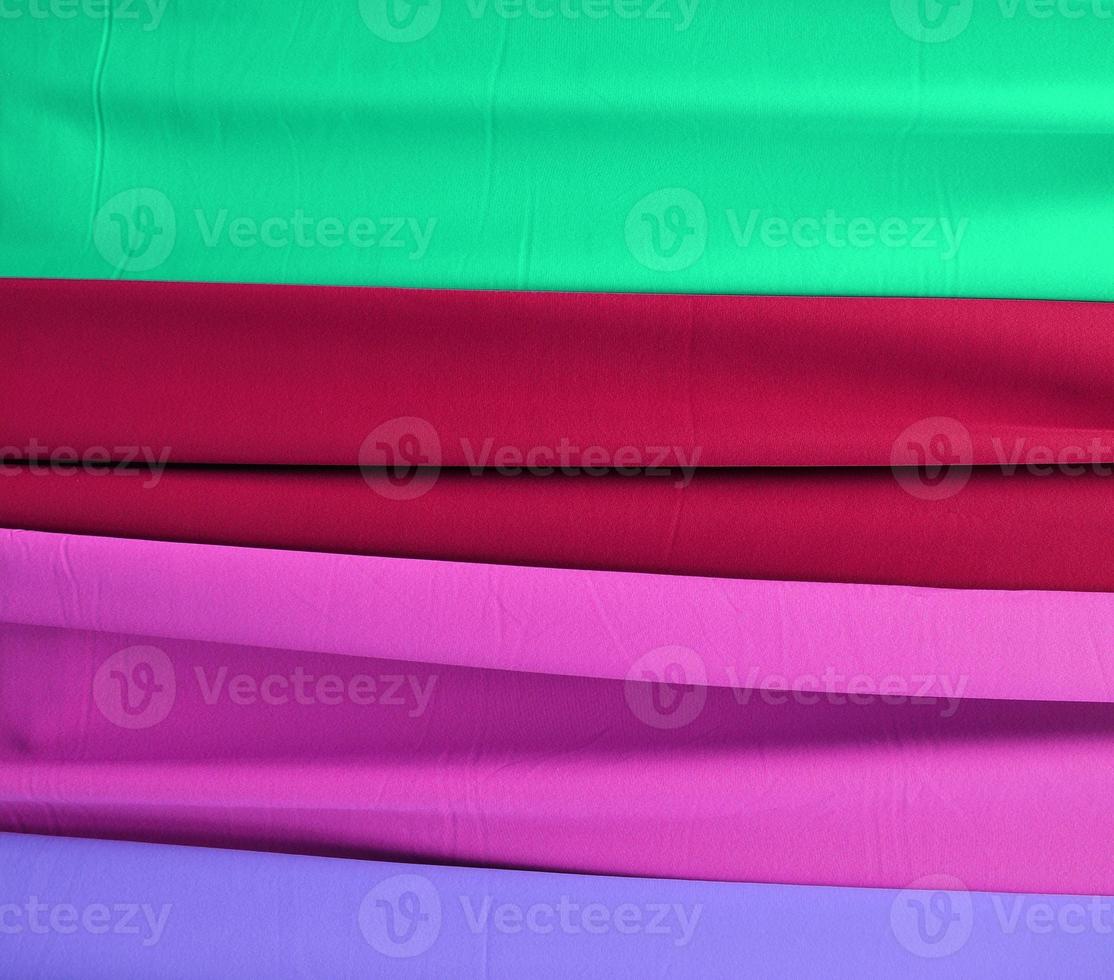 Detailed close up view on samples of cloth and fabrics in different colors found at a fabrics market photo