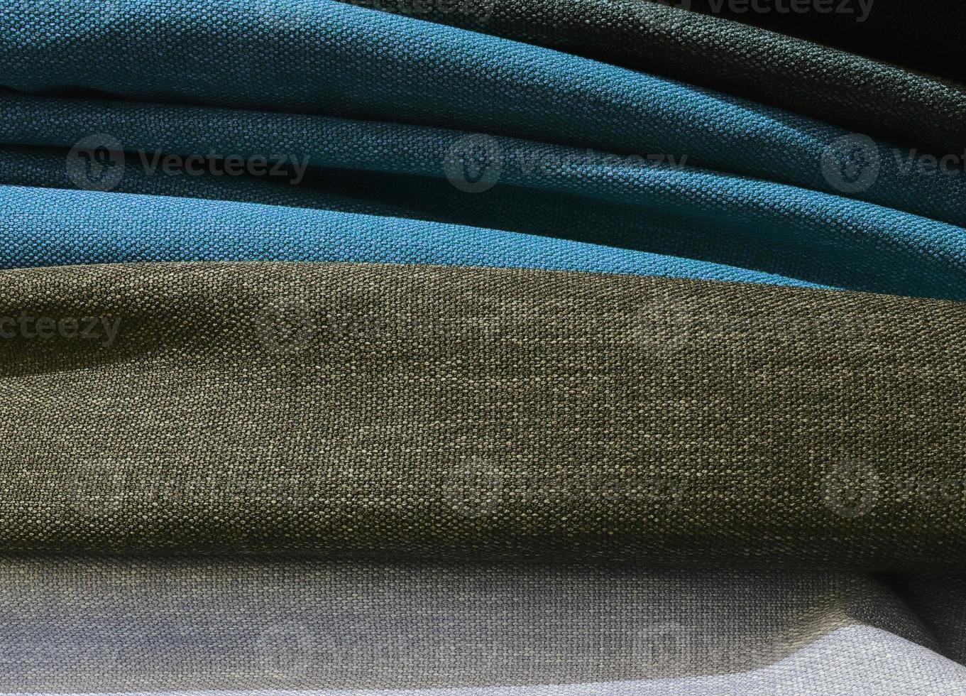 Detailed close up view on samples of cloth and fabrics in different colors found at a fabrics market photo