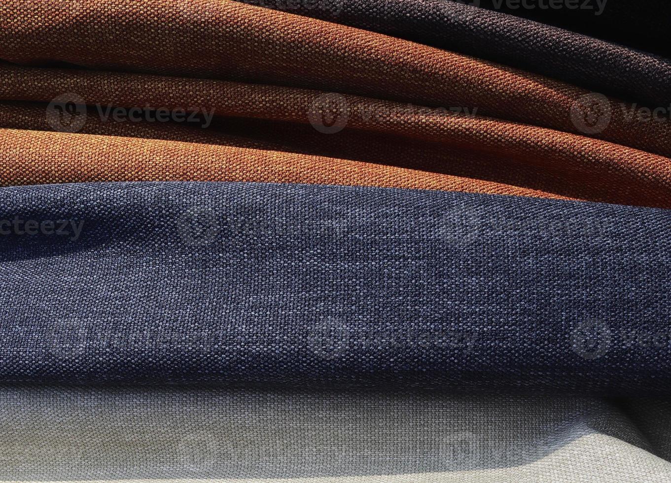 Detailed close up view on samples of cloth and fabrics in different colors found at a fabrics market photo