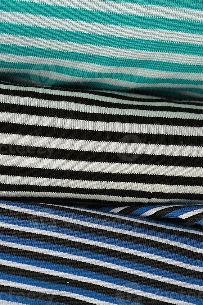 Detailed close up view on samples of cloth and fabrics in different colors found at a fabrics market photo