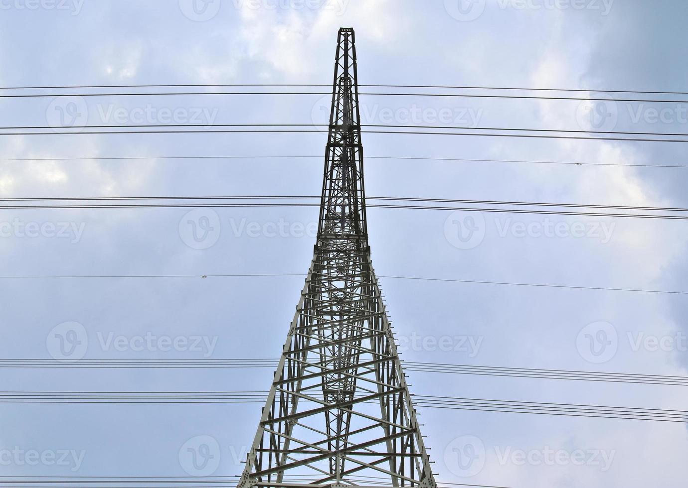 Close up view on a big power pylon transporting electricity in a countryside area photo