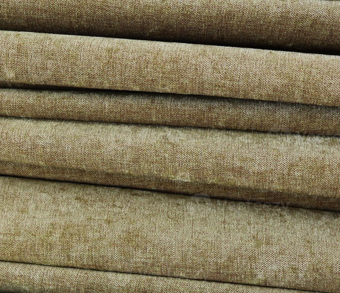 Detailed close up view on samples of cloth and fabrics in different colors found at a fabrics market photo
