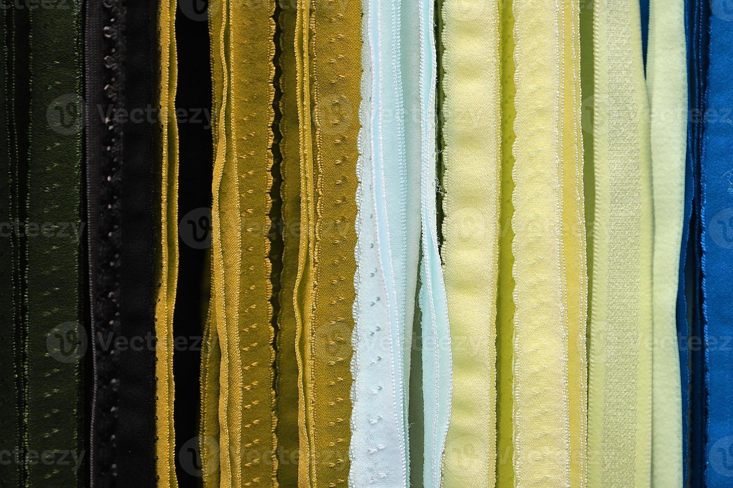 Detailed close up view on samples of cloth and fabrics in different colors found at a fabrics market photo