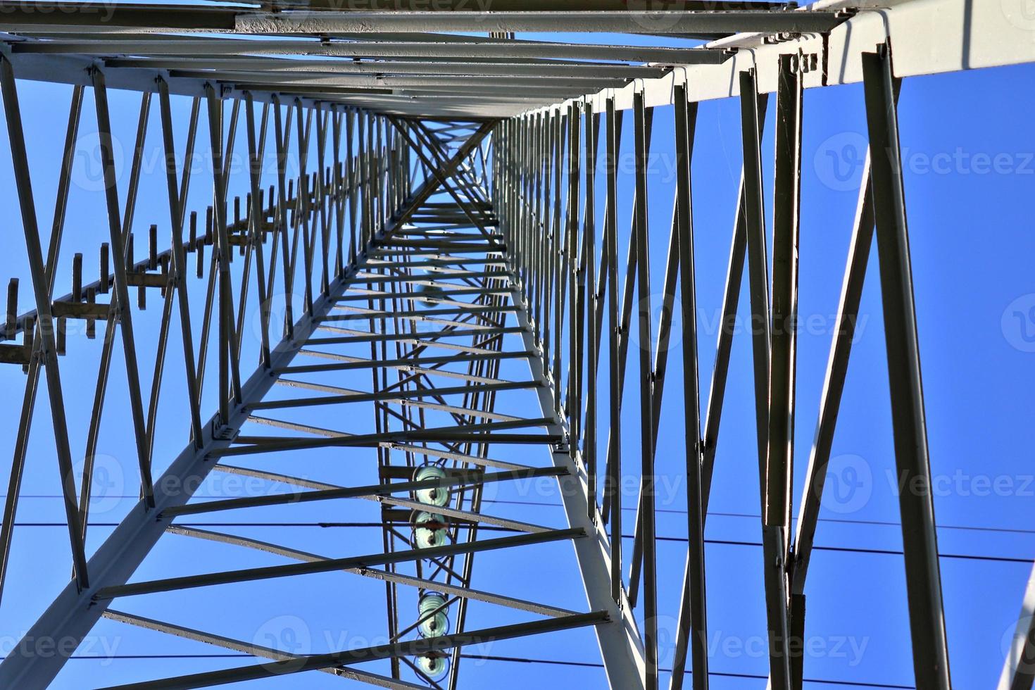 Close up view on a big power pylon transporting electricity in a countryside area photo