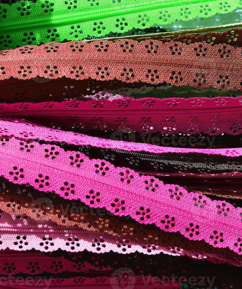 Detailed close up view on samples of cloth and fabrics in different colors found at a fabrics market photo