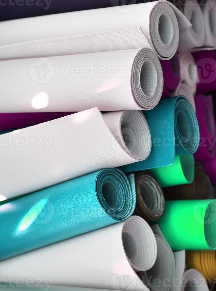 Detailed close up view on samples of cloth and fabrics in different colors found at a fabrics market photo