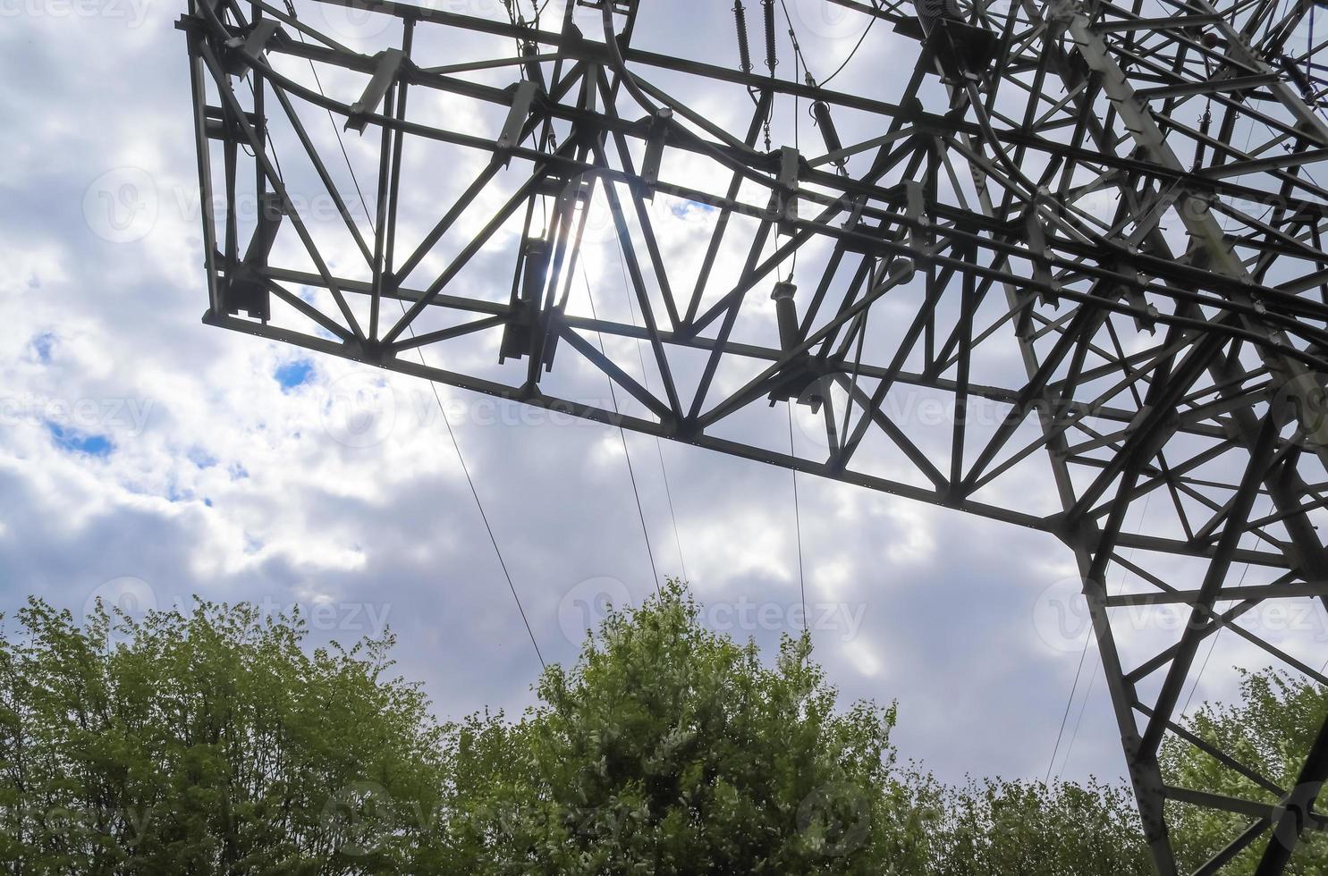 Close up view on a big power pylon transporting electricity in a countryside area photo