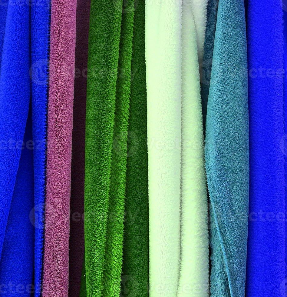 Detailed close up view on samples of cloth and fabrics in different colors found at a fabrics market photo