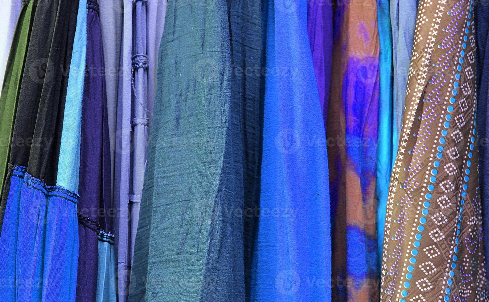 Detailed close up view on samples of cloth and fabrics in different colors found at a fabrics market photo