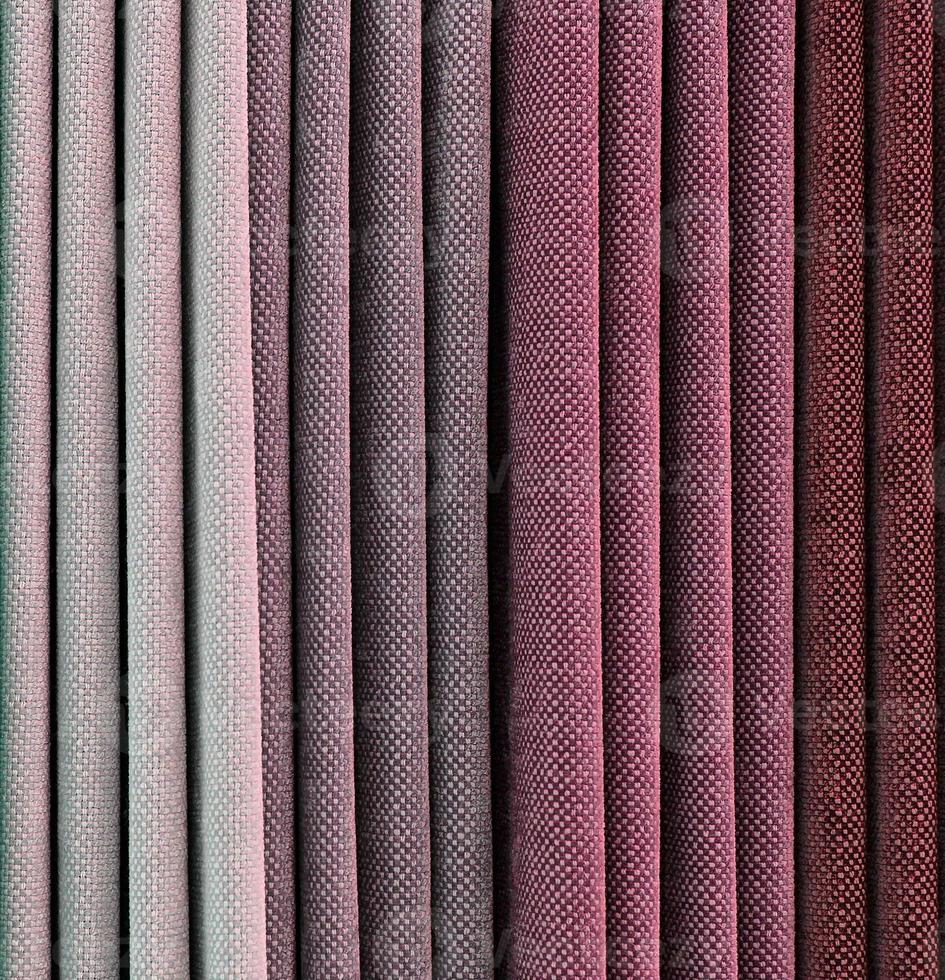 Detailed close up view on samples of cloth and fabrics in different colors found at a fabrics market photo