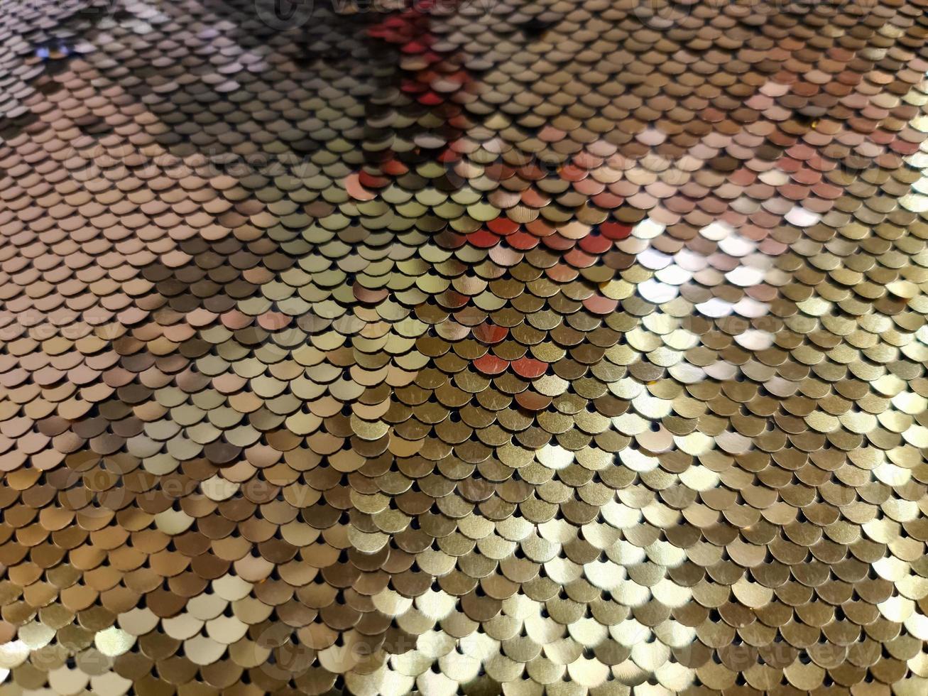 Close up view on samples of sequin fabric in golden colors photo