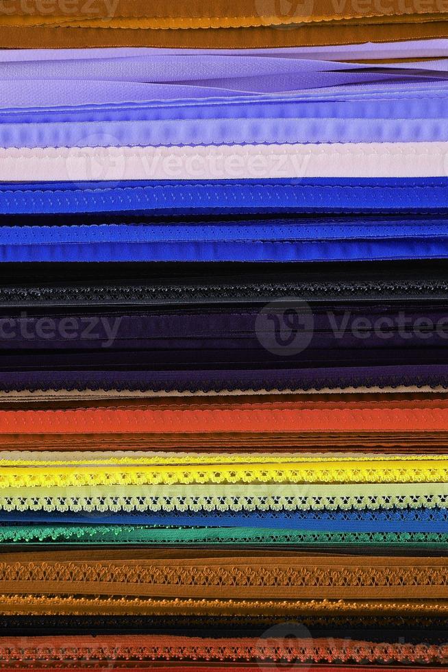 Detailed close up view on samples of cloth and fabrics in different colors found at a fabrics market photo