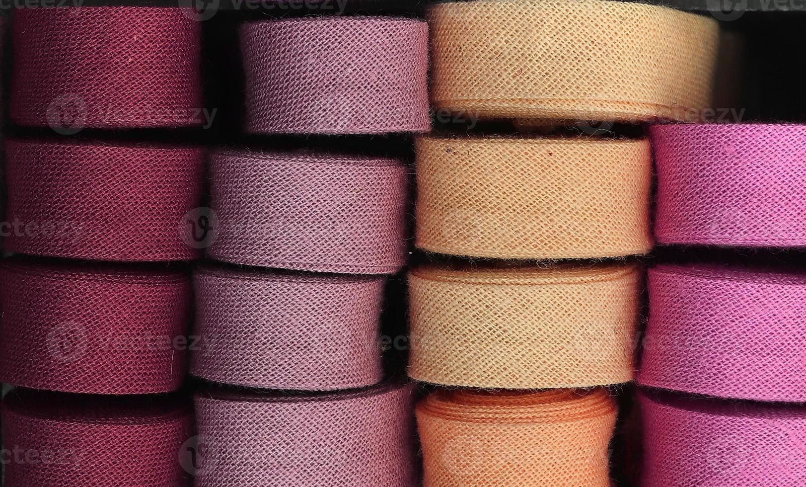 Detailed close up view on samples of cloth and fabrics in different colors found at a fabrics market photo
