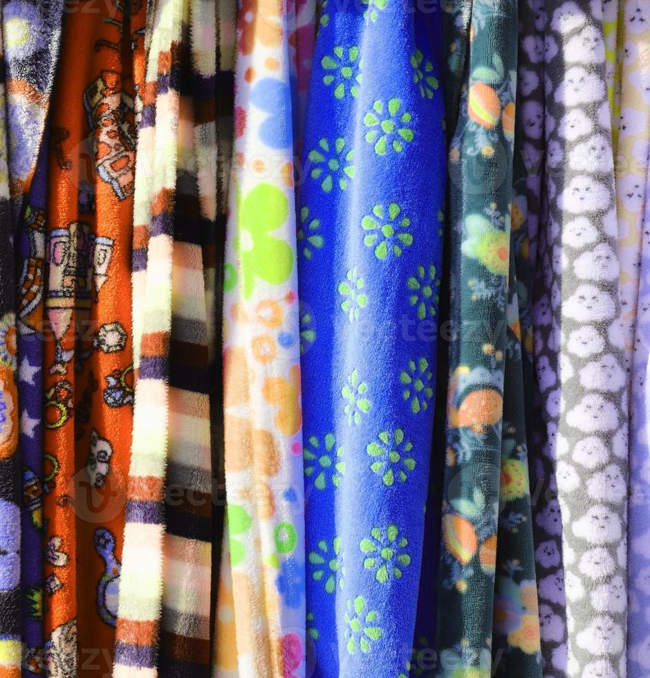 Detailed close up view on samples of cloth and fabrics in different colors found at a fabrics market photo