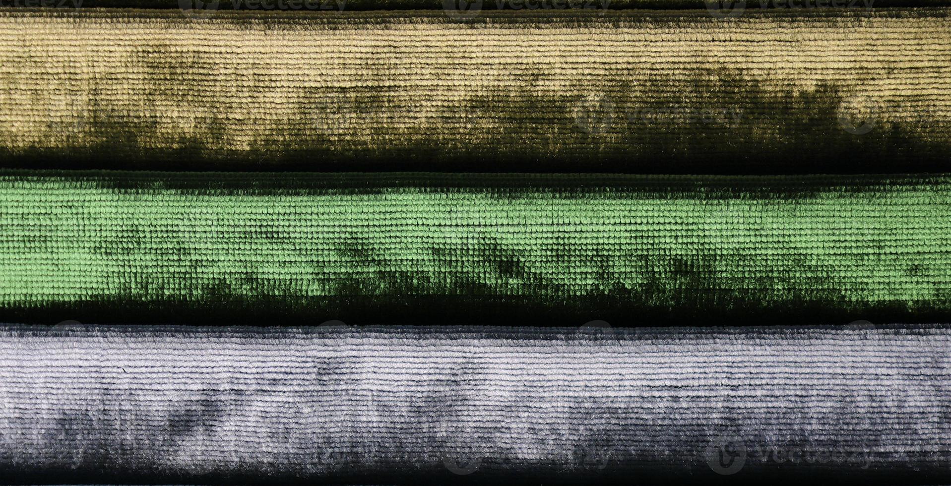 Detailed close up view on samples of cloth and fabrics in different colors found at a fabrics market photo