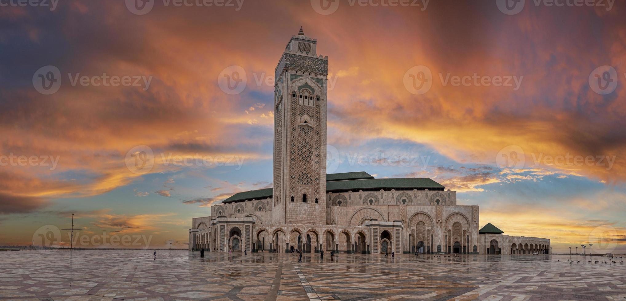 Low angle view of historic Mosque Hasan II with tallest minaret against dramatic sky photo