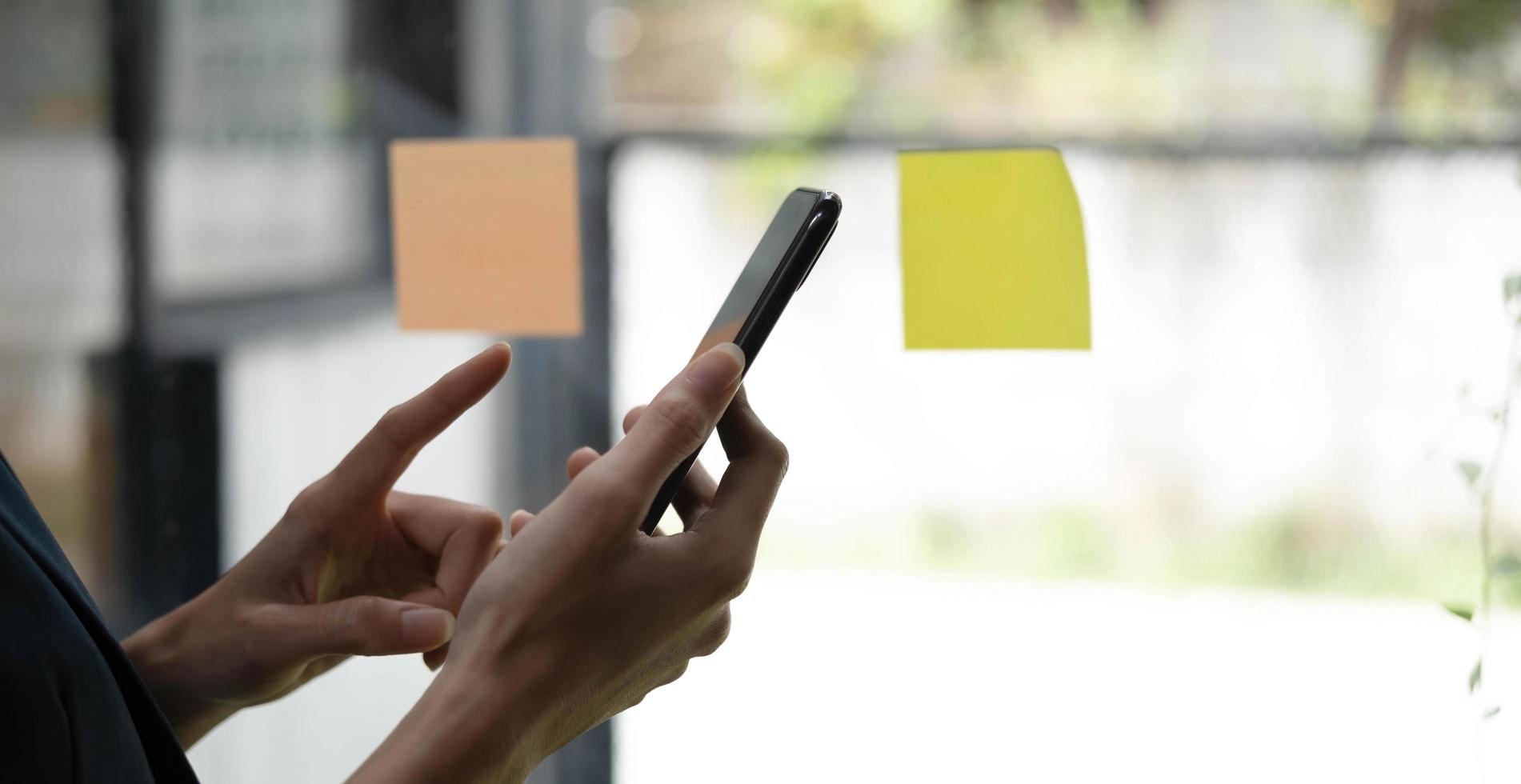 Close up woman holding smartphone, typing message, texting, chatting, female hands using cellphone, browsing mobile apps, internet, checking social networks, email, playing games on phone photo