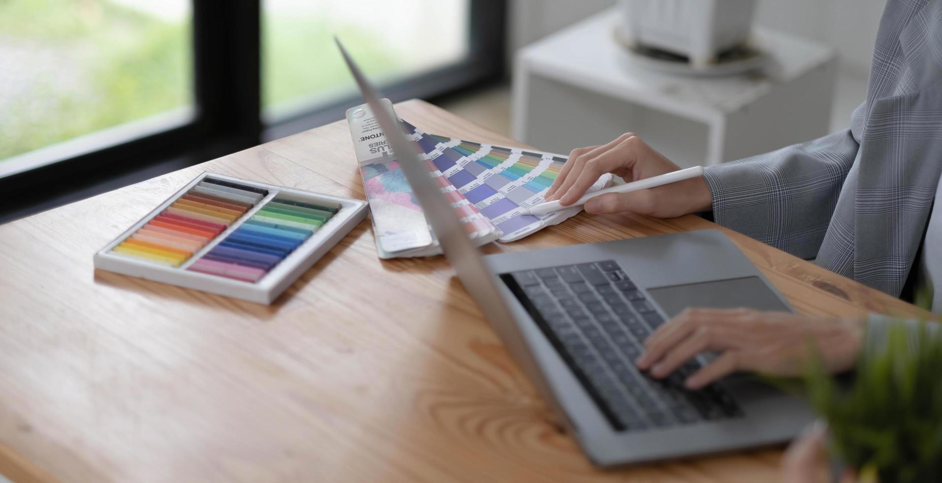 Close-up view of young graphic designer editing his project in comfortable working space photo