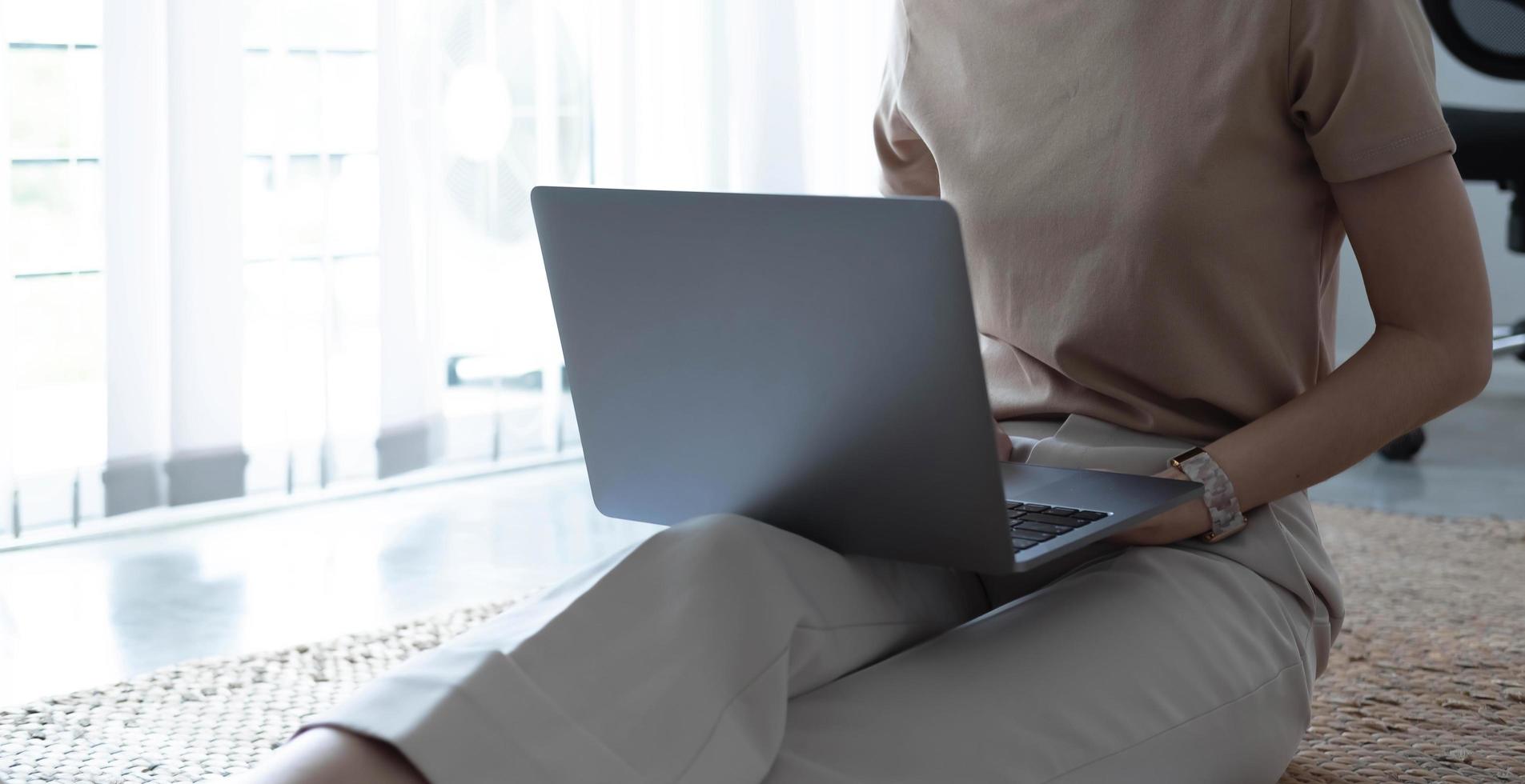 Close up image of woman hands typing on laptop computer keyboard and surfing the internet on office table, online, working, business and technology, internet network communication concept photo