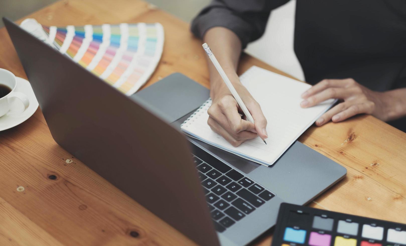 Young asian female designer using graphics tablet while working with computer at studio or office. photo