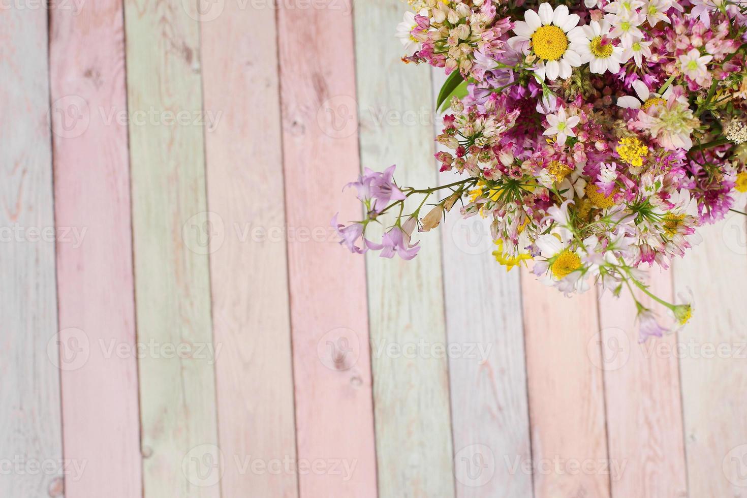 Colorful wooden table and flowers photo