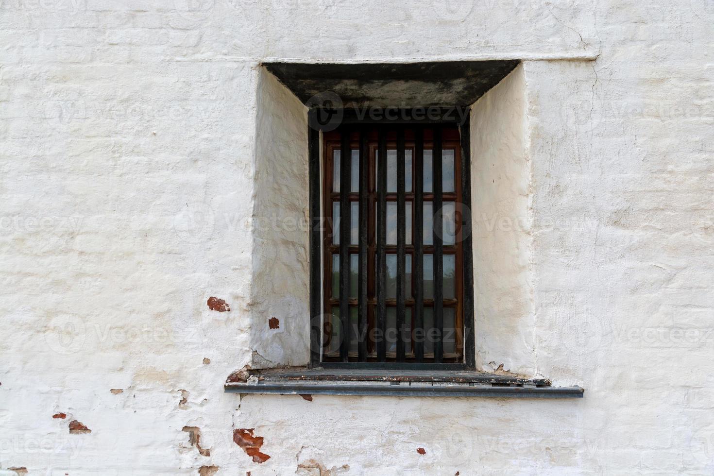 window with bars in an old medieval castle. photo