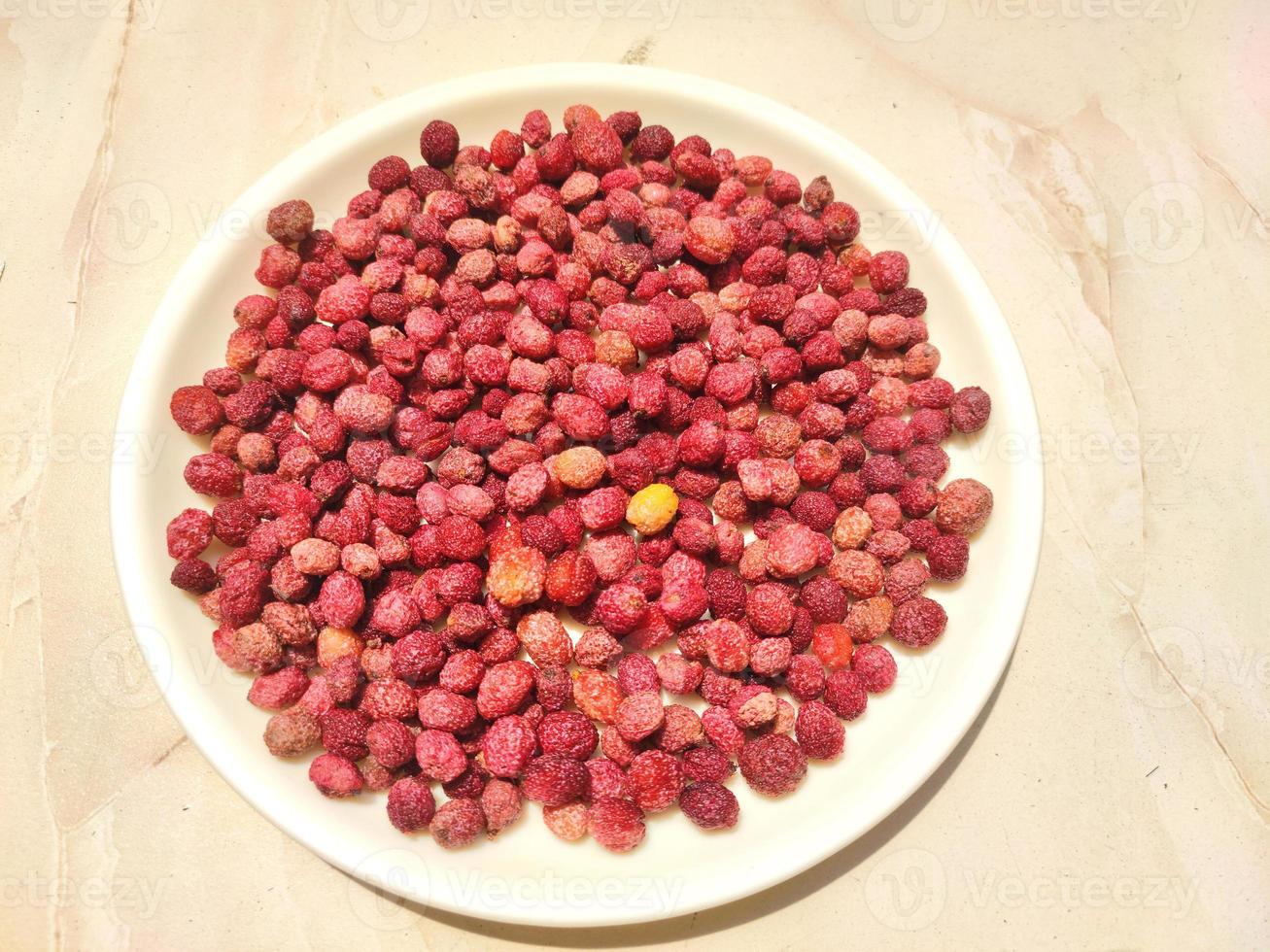 Berry like fruit - Kafal, the state fruit of Uttarakhand on a white plate on a light background. photo