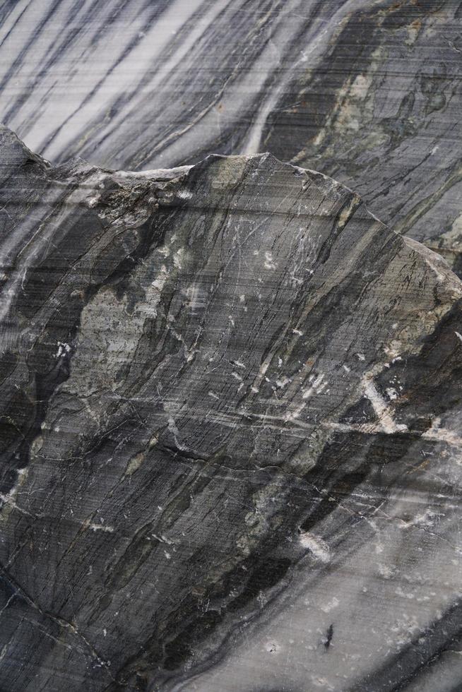 Surface of a cut of gray Karelian marble rock in Ruskeala in Karelia photo