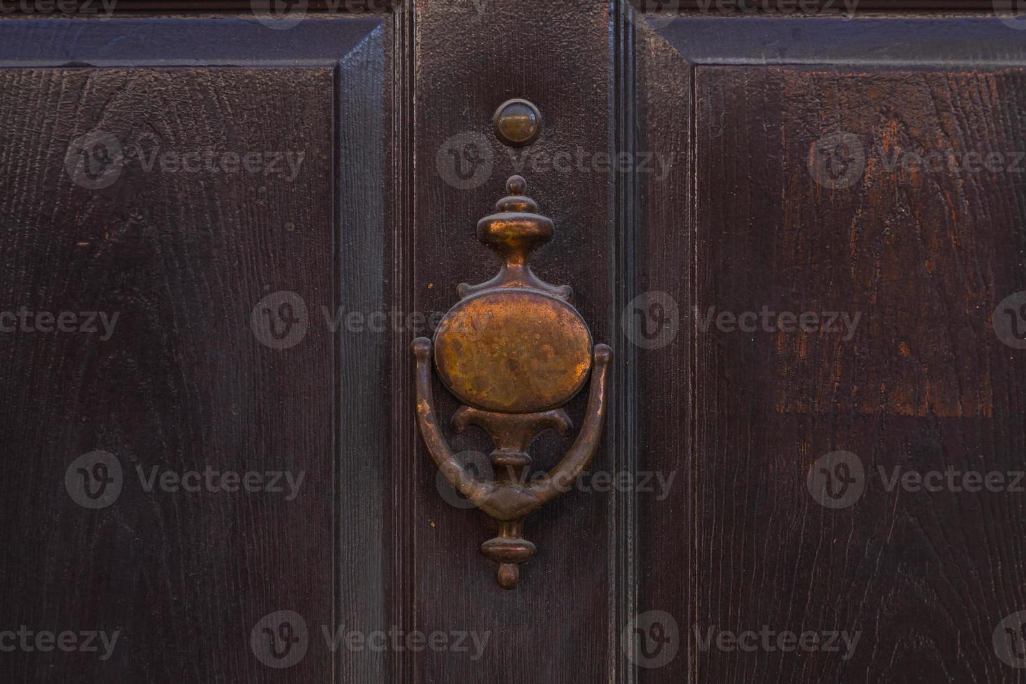 old-fashioned metal handle.Doorknocker on allwood door. photo