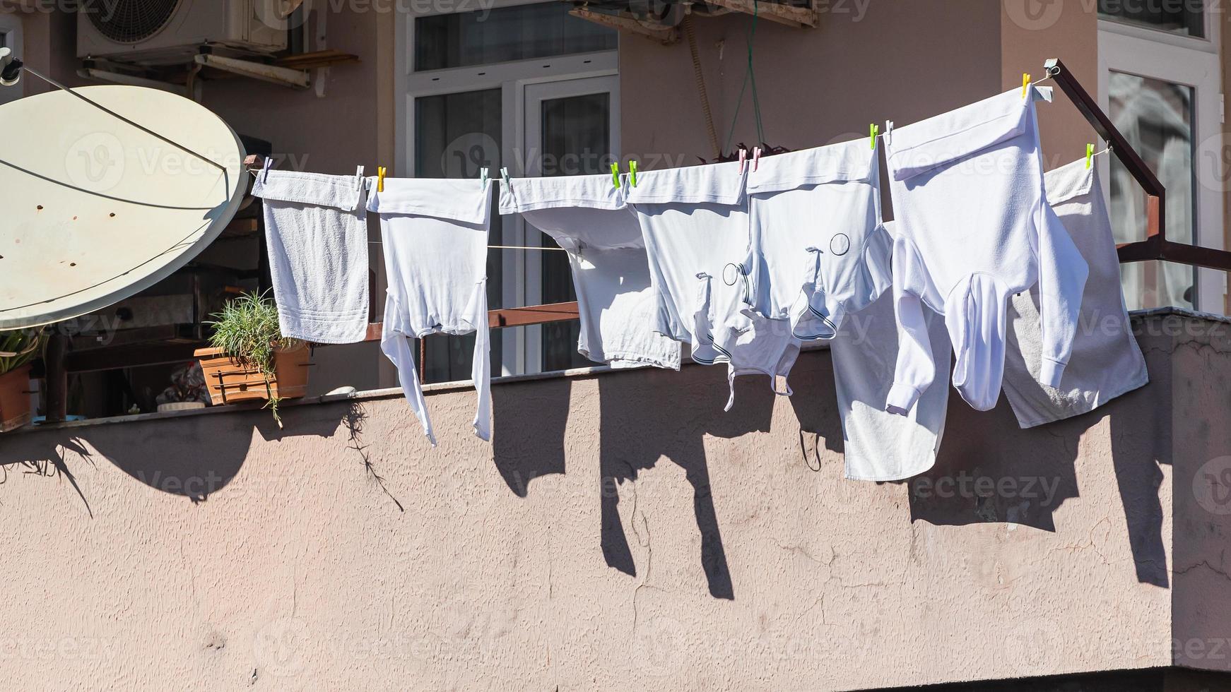 A stone  house in an turkish  city, laundry is drying on a rope photo