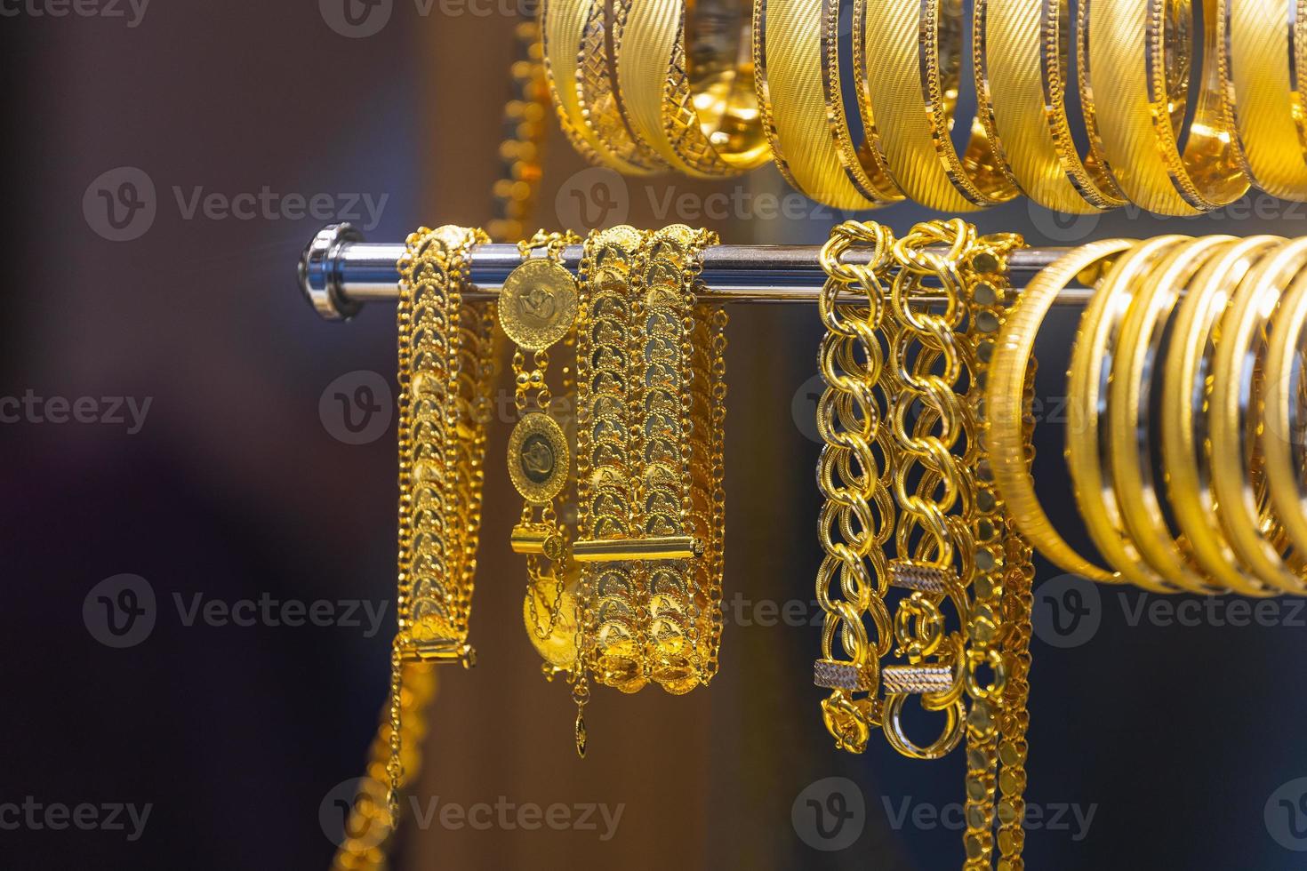Jewelry shop window with a huge selection of gold jewelry bracelets, chains photo
