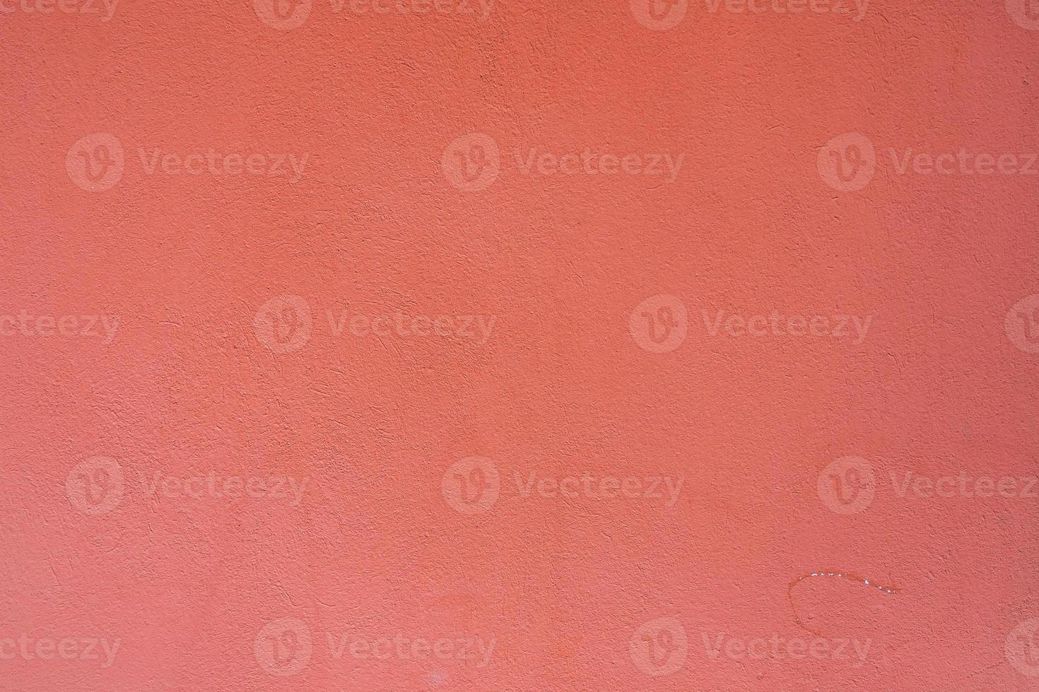 Background from a  pattern of pink stone wall covered with decorative plaster. photo
