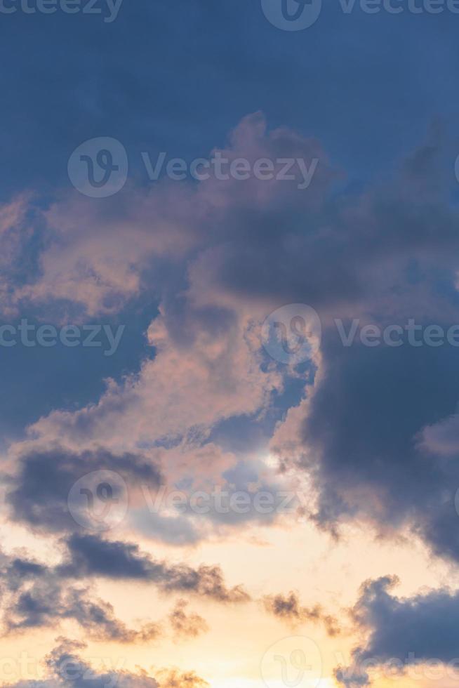 Blue sky background with tiny sunset clouds  in summer season. Cloud texture photo