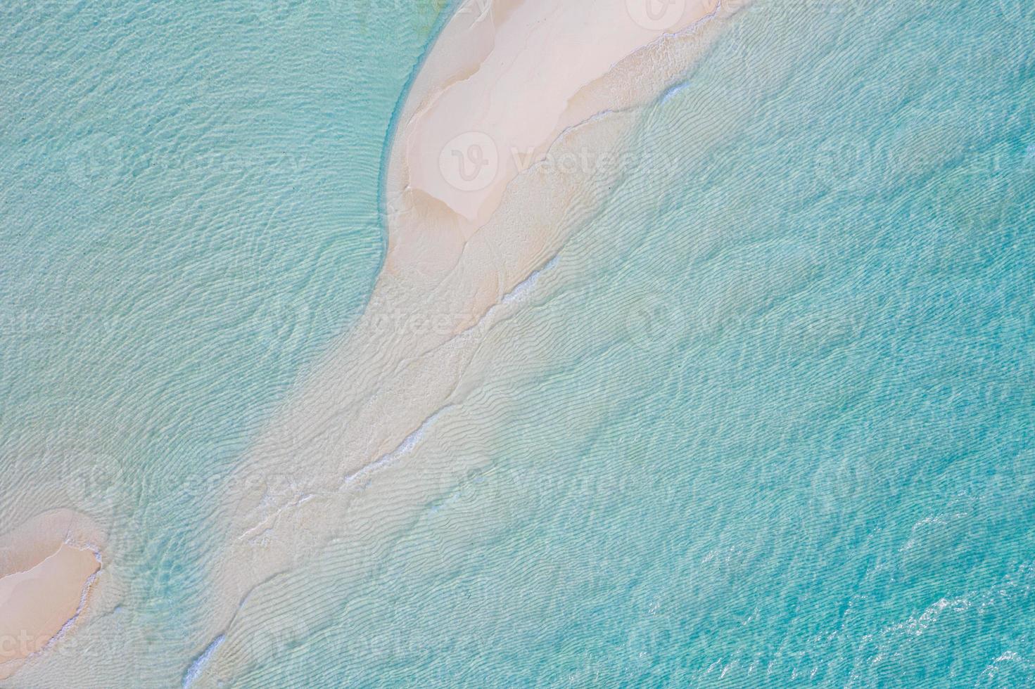 Summer seascape beautiful waves, blue sea water in sunny day. Top view from drone. Sea aerial view, amazing tropical nature background. Beautiful bright sea with waves splashing and beach sand concept photo