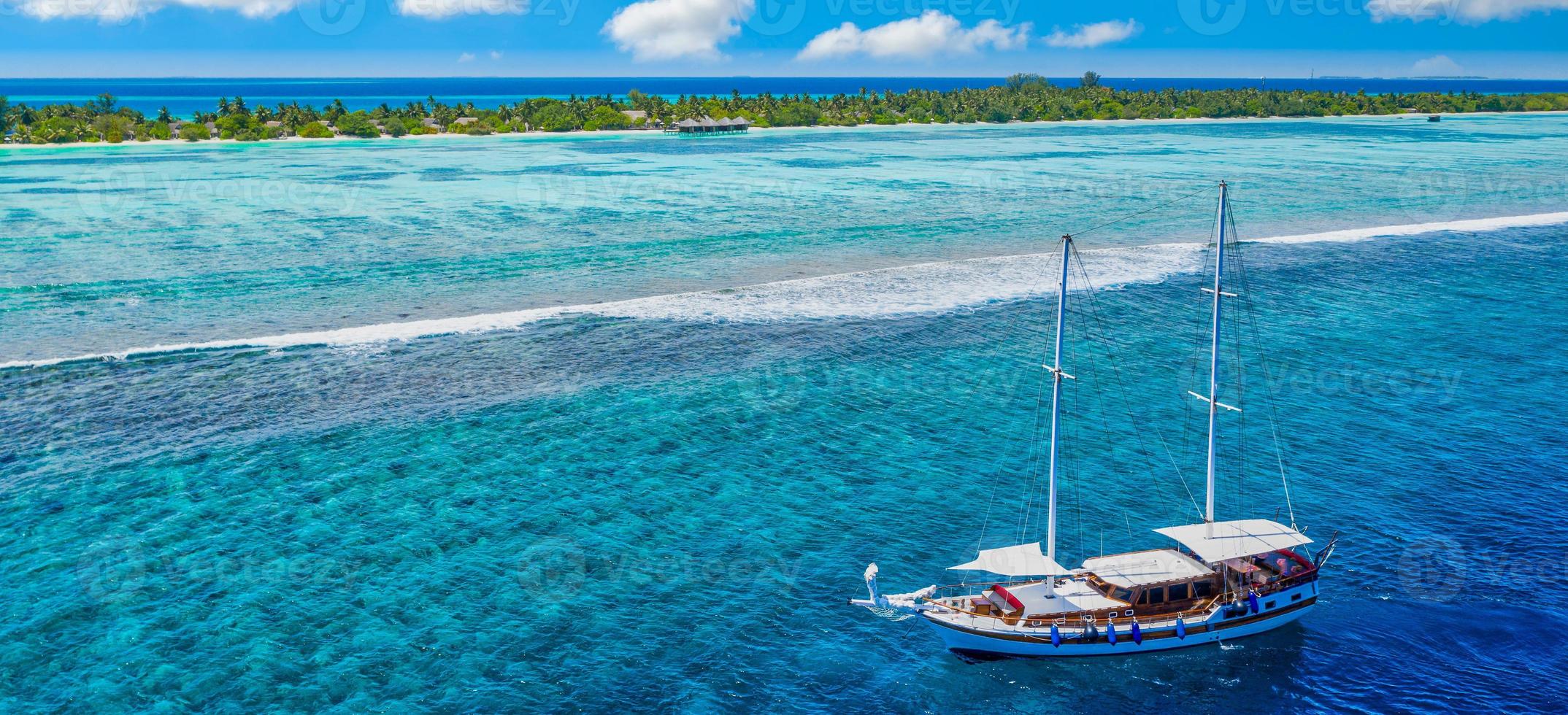 Panoramic turquoise ocean water sailboat, view aerial drone seascape. Tropical sea waves, amazing aerial coral reef, lagoon. People recreational outdoor activity, swimming, snorkeling, diving tourism photo