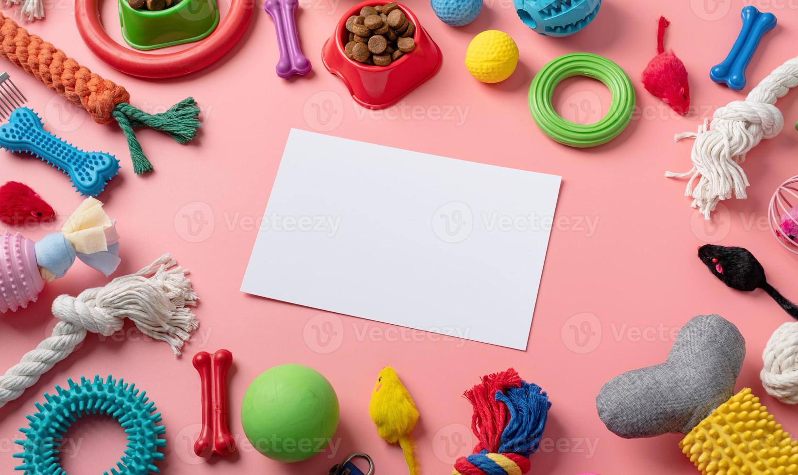 Pet care concept, various pet accessories and tools on pink background with blank paper, high angle view photo