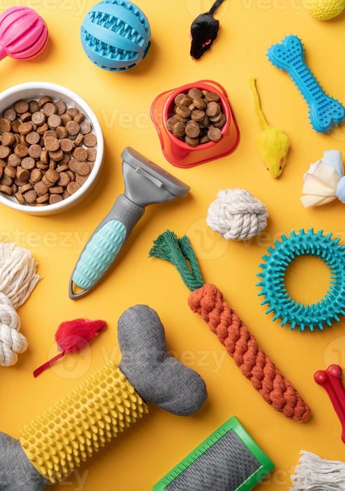 Pet care concept, various pet accessories and tools on yellow background, flat lay photo